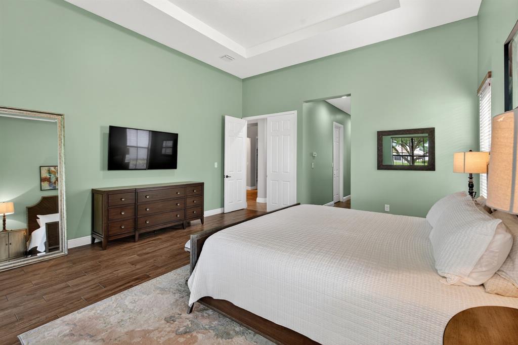 5294 Ferrari Avenue Ave Maria, FL 34142 - Photo 28 of 42 a bedroom with a bed and a flat screen tv