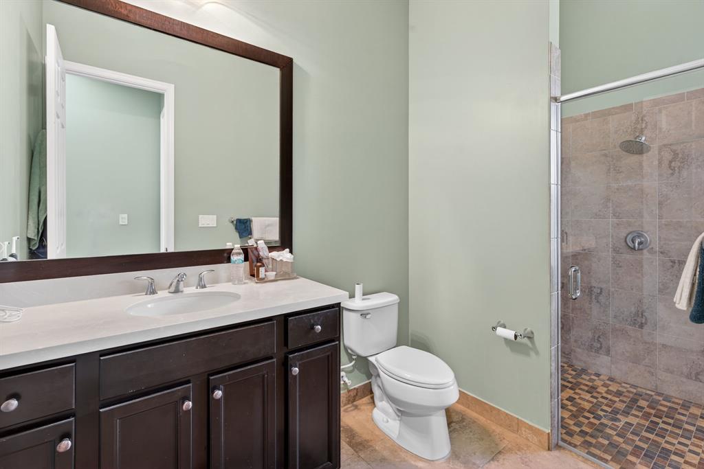 5294 Ferrari Avenue Ave Maria, FL 34142 - Photo 30 of 42 a bathroom with a granite countertop sink toilet and shower