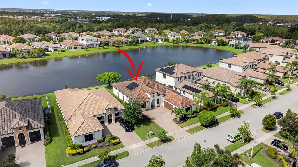 5294 Ferrari Avenue Ave Maria, FL 34142 - Photo 35 of 42 an aerial view of a house with a lake view