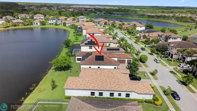 an aerial view of a house with a lake view