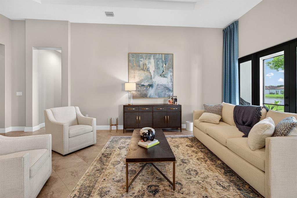 5294 Ferrari Avenue Ave Maria, FL 34142 - Photo 6 of 42 a living room with furniture and a large window