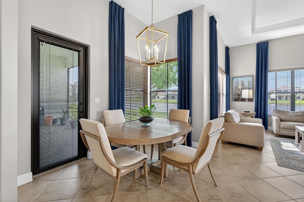 5294 Ferrari Avenue Ave Maria, FL 34142 - Photo 9 of 42 a dining room with furniture and large windows