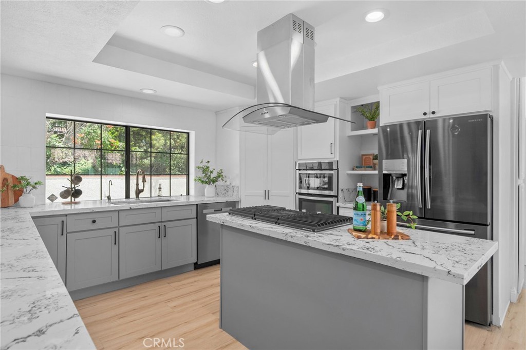 5087 Granada Court Rancho Cucamonga, CA 91737 - Photo 18 of 49 a kitchen with stainless steel appliances granite countertop a sink and a refrigerator