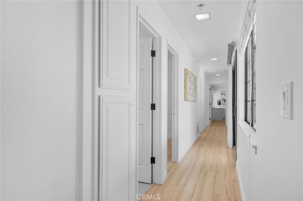 5087 Granada Court Rancho Cucamonga, CA 91737 - Photo 22 of 49 a view of a hallway with wooden floor