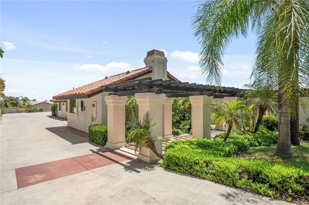 5087 Granada Court Rancho Cucamonga, CA 91737 - Photo 3 of 49 a front view of a house with garden