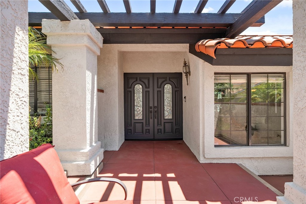 5087 Granada Court Rancho Cucamonga, CA 91737 - Photo 4 of 49 a view of a porch with a table and chairs
