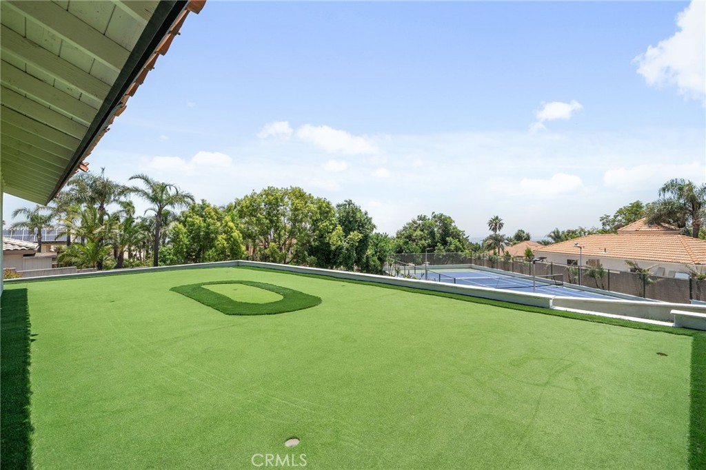 5087 Granada Court Rancho Cucamonga, CA 91737 - Photo 44 of 49 a view of a green field with wooden fence
