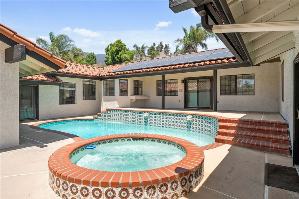 5087 Granada Court Rancho Cucamonga, CA 91737 - Photo 45 of 49 front view of a house with a swimming pool