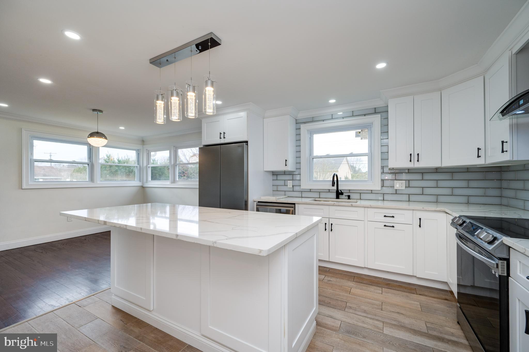 12 Vista Road Reading, PA 19610 - Photo 15 of 39 a kitchen with stainless steel appliances a sink a stove a refrigerator cabinets and a dining table