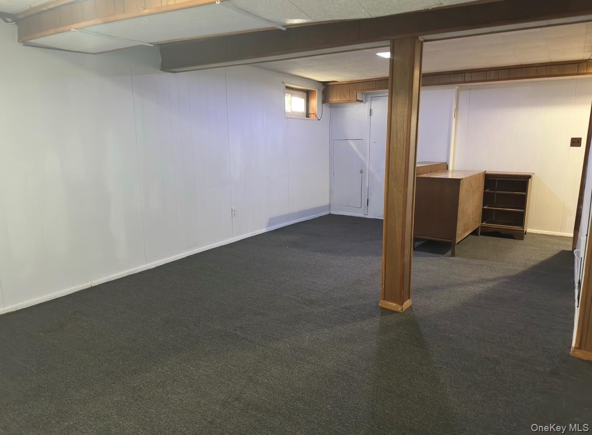 484 Chelsea Road Oceanside, NY 11572 - Photo 18 of 23 Below grade area with dark colored carpet