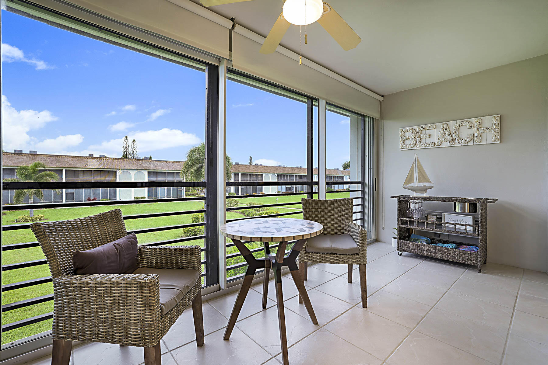 755 Saturn Street, Unit F203 Jupiter, FL 33477 - Photo 12 of 36 a room with furniture and a floor to ceiling window