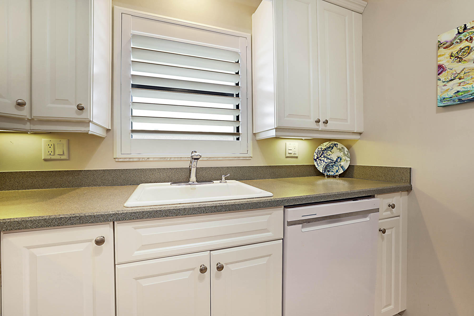 755 Saturn Street, Unit F203 Jupiter, FL 33477 - Photo 23 of 36 a kitchen with a sink and cabinets