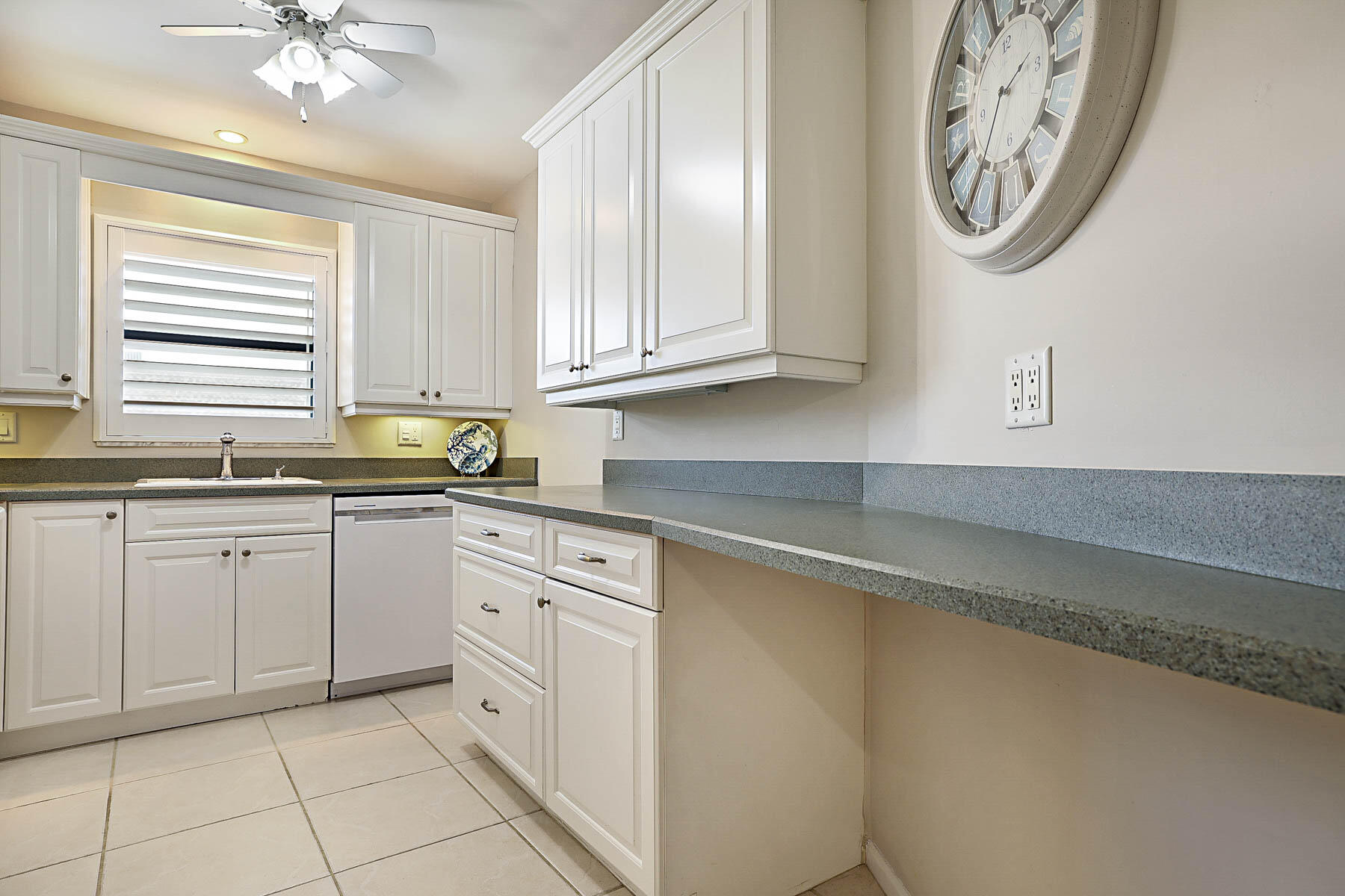 755 Saturn Street, Unit F203 Jupiter, FL 33477 - Photo 24 of 36 a kitchen with cabinets and a large window