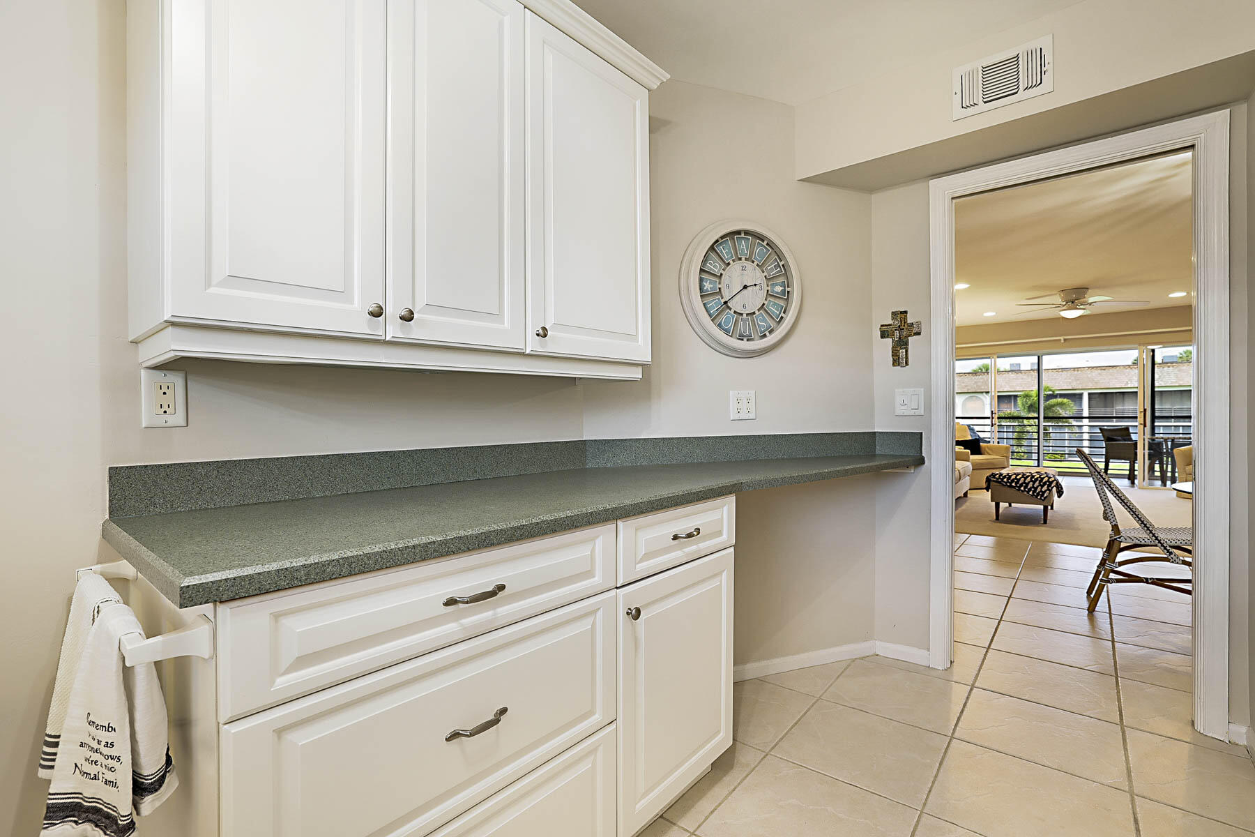 755 Saturn Street, Unit F203 Jupiter, FL 33477 - Photo 25 of 36 a kitchen with a white cabinets and outdoor seating