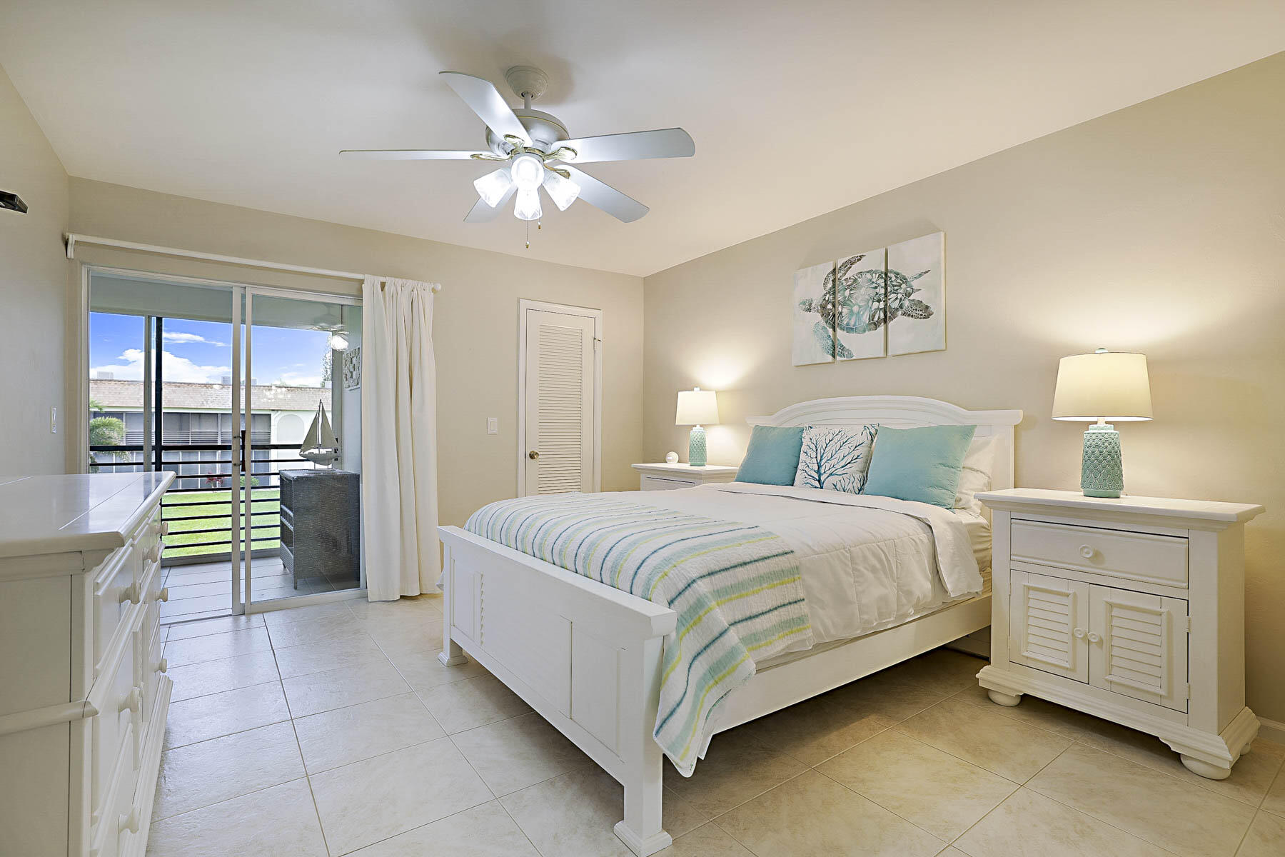755 Saturn Street, Unit F203 Jupiter, FL 33477 - Photo 26 of 36 a bedroom with a bed and a chandelier