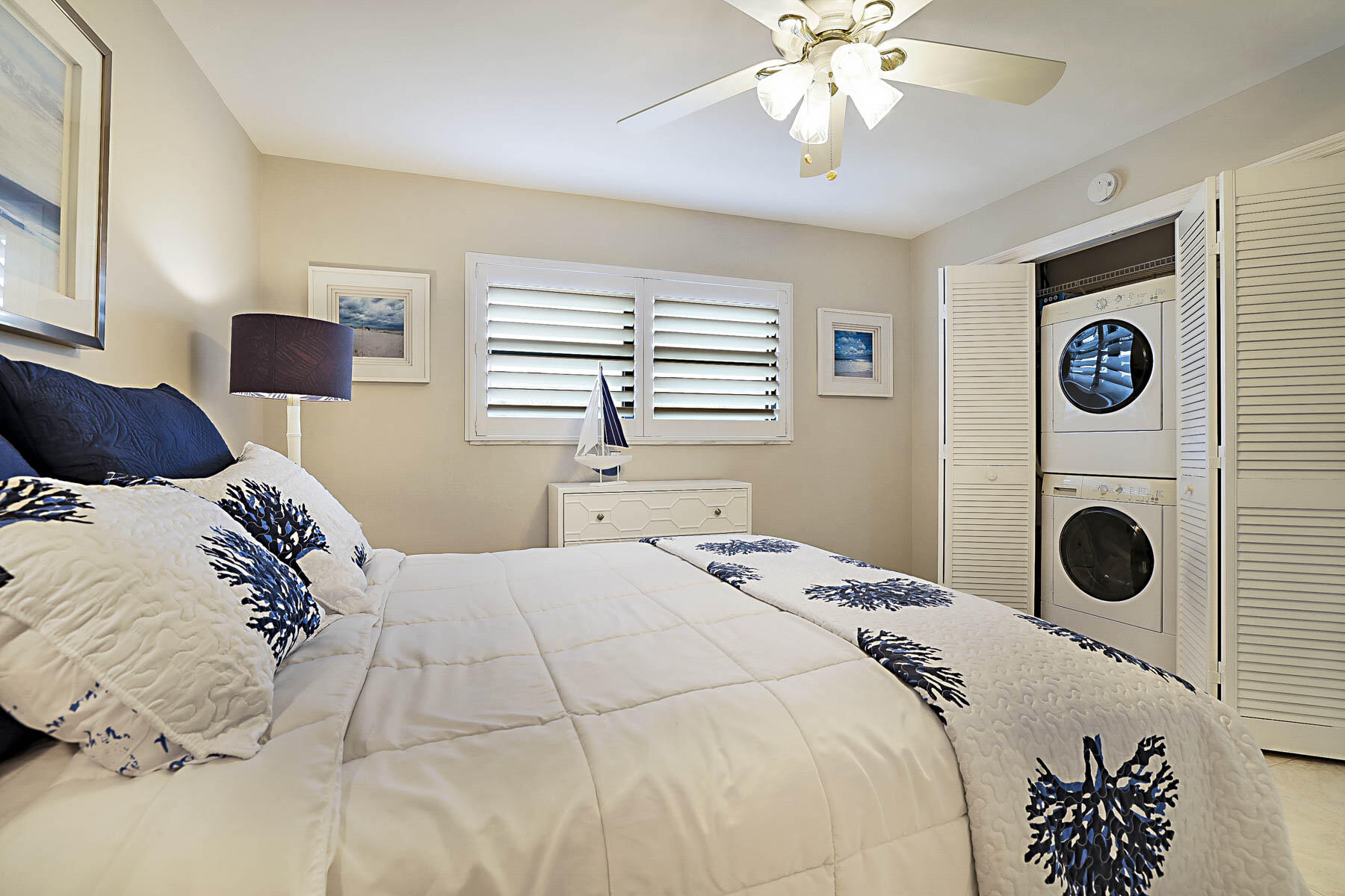 755 Saturn Street, Unit F203 Jupiter, FL 33477 - Photo 31 of 36 a bedroom with a bed and a chandelier