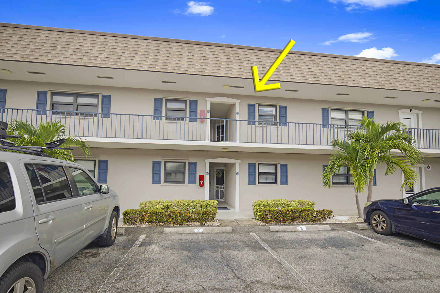 755 Saturn Street, Unit F203 Jupiter, FL 33477 - Photo 33 of 36 a view of a car parked front of a house