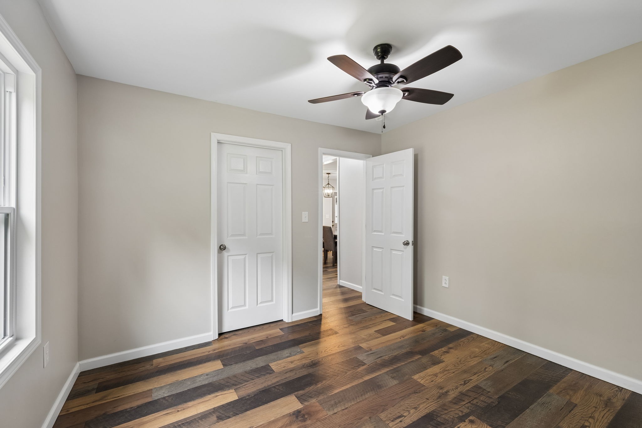 121 Hannah Road Summertown, TN 38483 - Photo 24 of 52 a view of an empty room with wooden floor and a ceiling fan