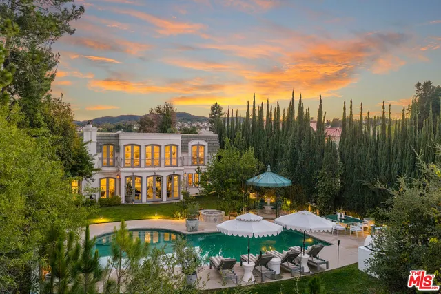 a front view of a house with garden and plants