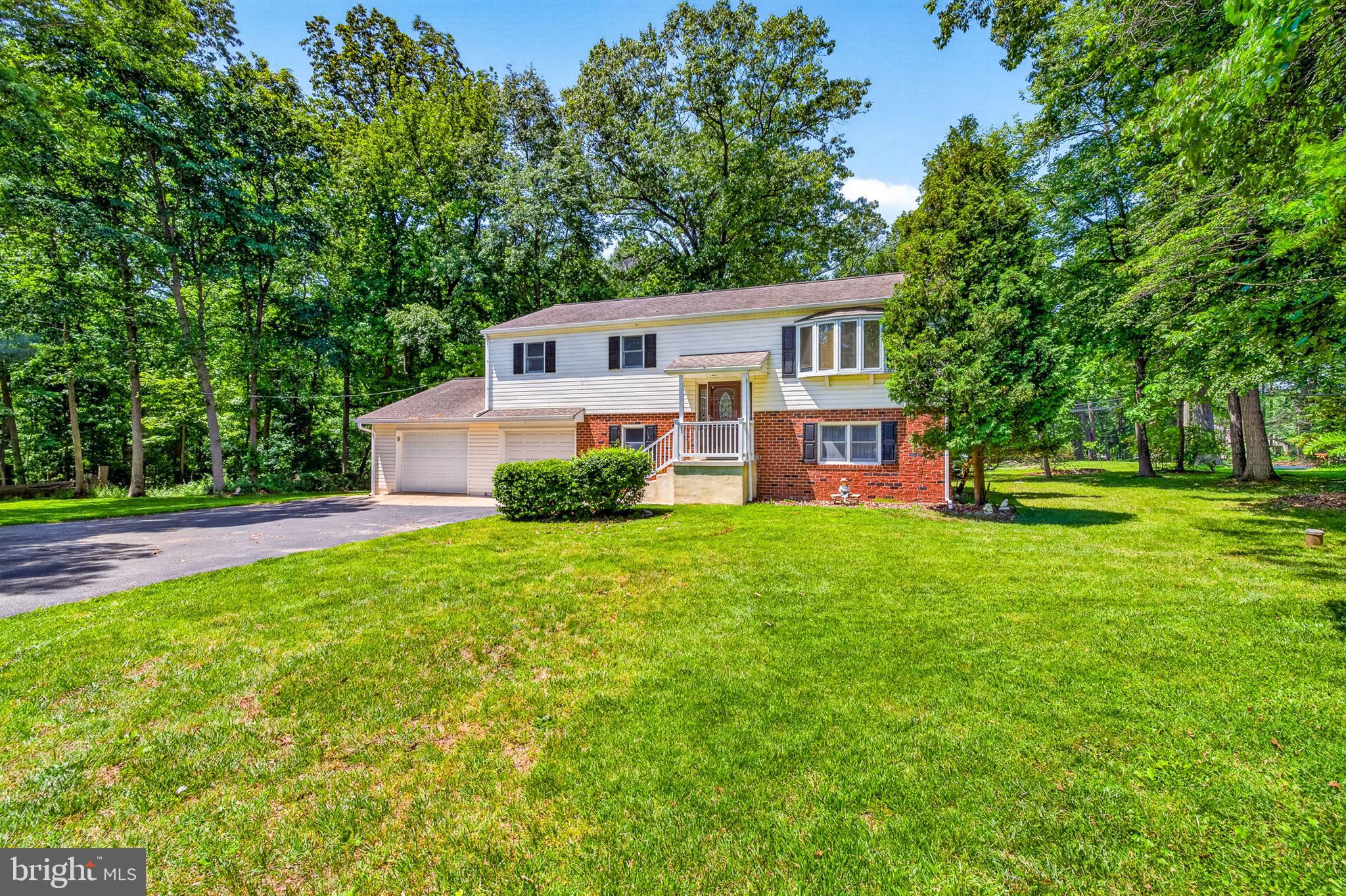 3701 Ebright Road Chadds Ford, PA 19317 - Photo 5 of 45 a front view of a house with a yard and trees