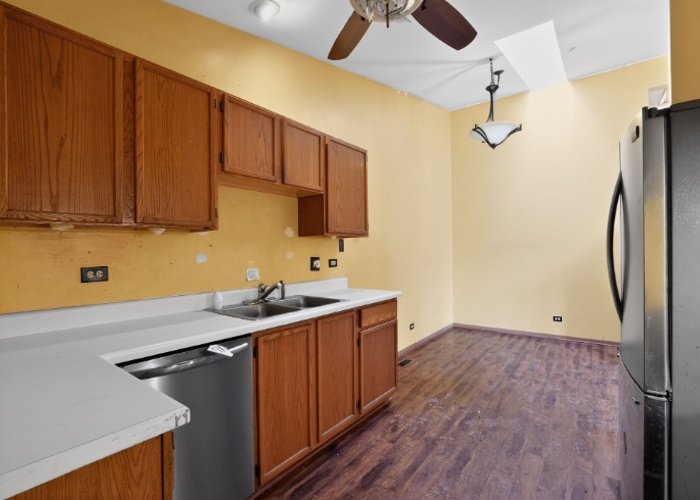 115 North McAree Road Waukegan, IL 60085 - Photo 11 of 21 a kitchen with stainless steel appliances a sink cabinets and wooden floor