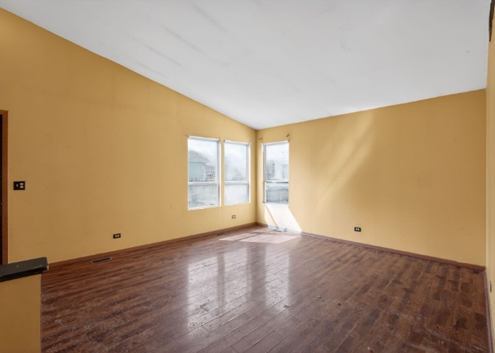115 North McAree Road Waukegan, IL 60085 - Photo 5 of 21 a view of an empty room with wooden floor and a window