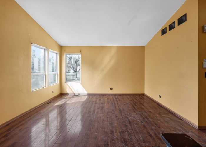 115 North McAree Road Waukegan, IL 60085 - Photo 9 of 21 an empty room with wooden floor and windows