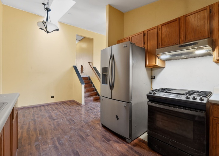 115 North McAree Road Waukegan, IL 60085 - Photo 10 of 21 a kitchen with a refrigerator and a stove top oven
