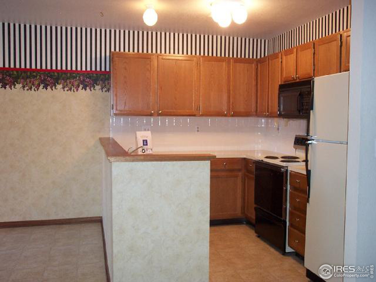 5809 West 18th Street Greeley, CO 80634 - Photo 5 of 11 a kitchen with a sink appliances and cabinets