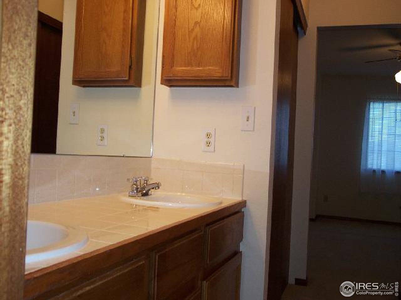 5809 West 18th Street Greeley, CO 80634 - Photo 10 of 11 a bathroom with a sink and a mirror