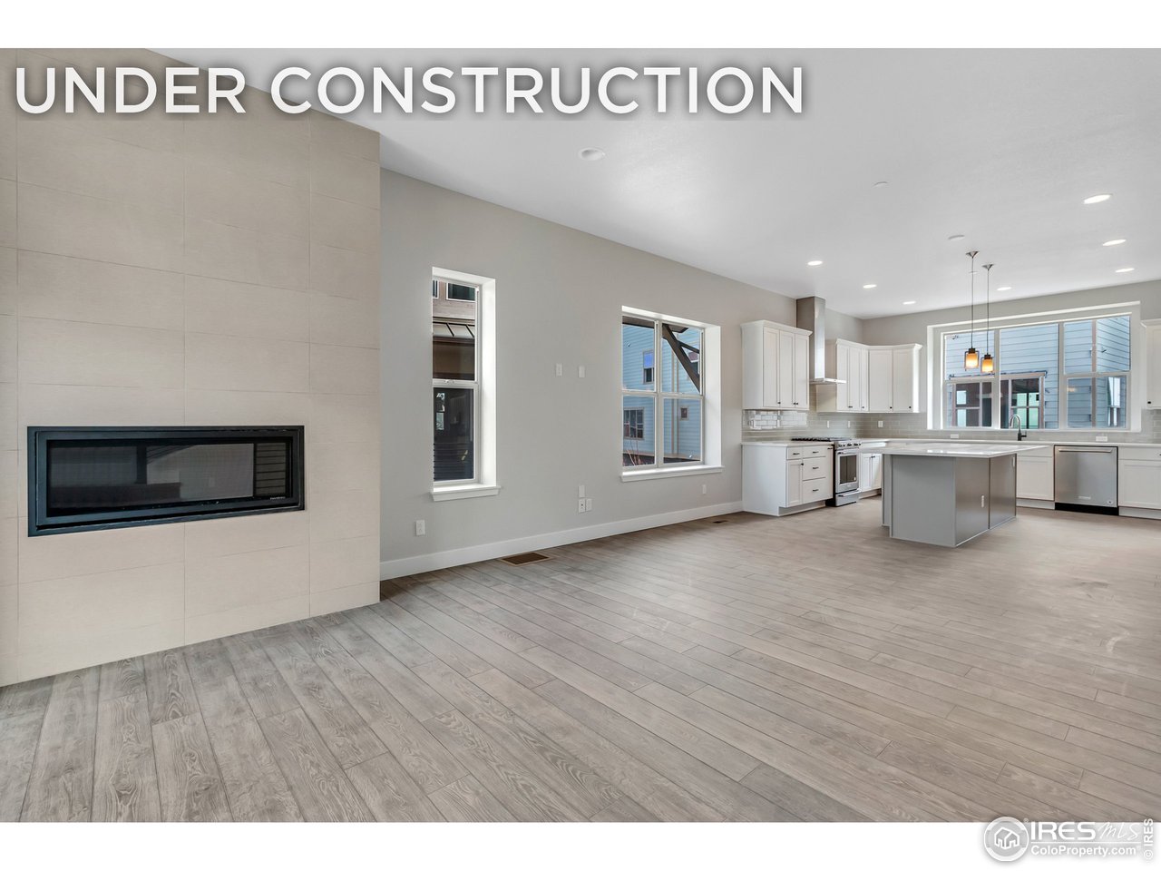 a view of an empty room with a kitchen