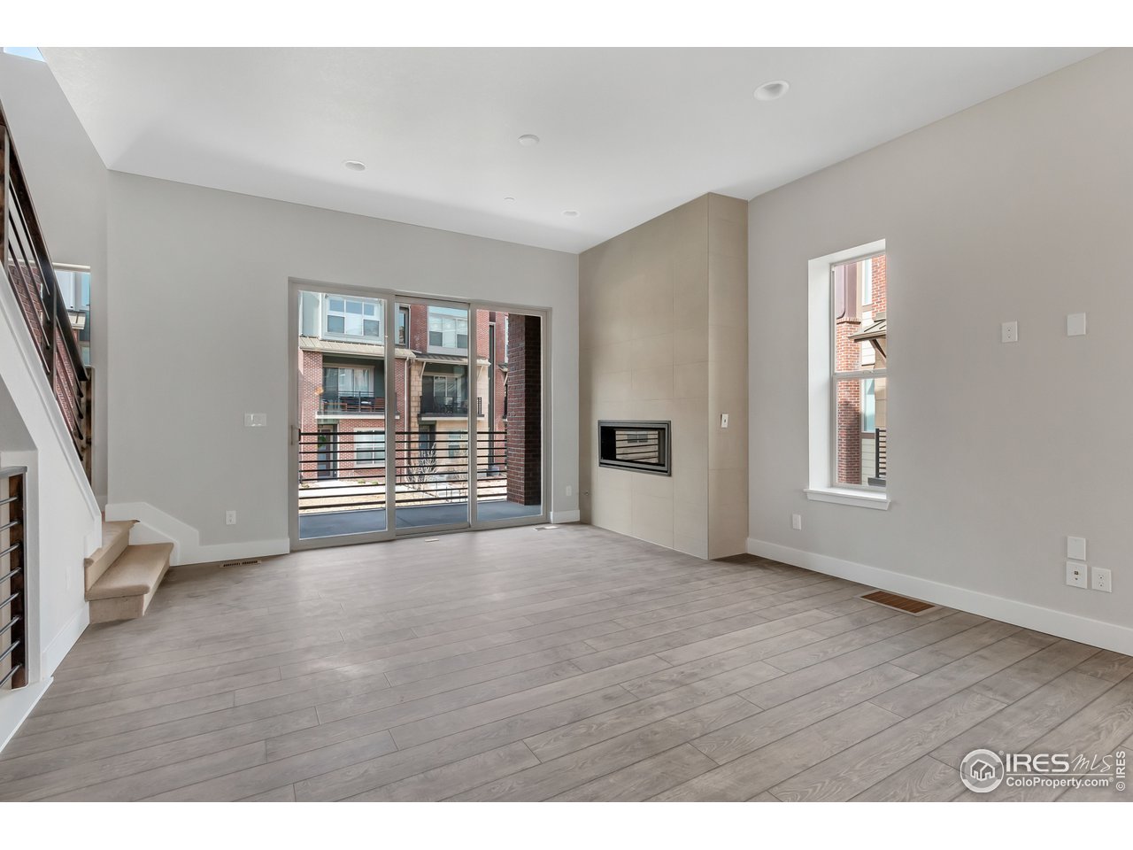587 Canary Lane Superior, CO 80027 - Photo 2 of 22 a view of an empty room with a window and wooden floor