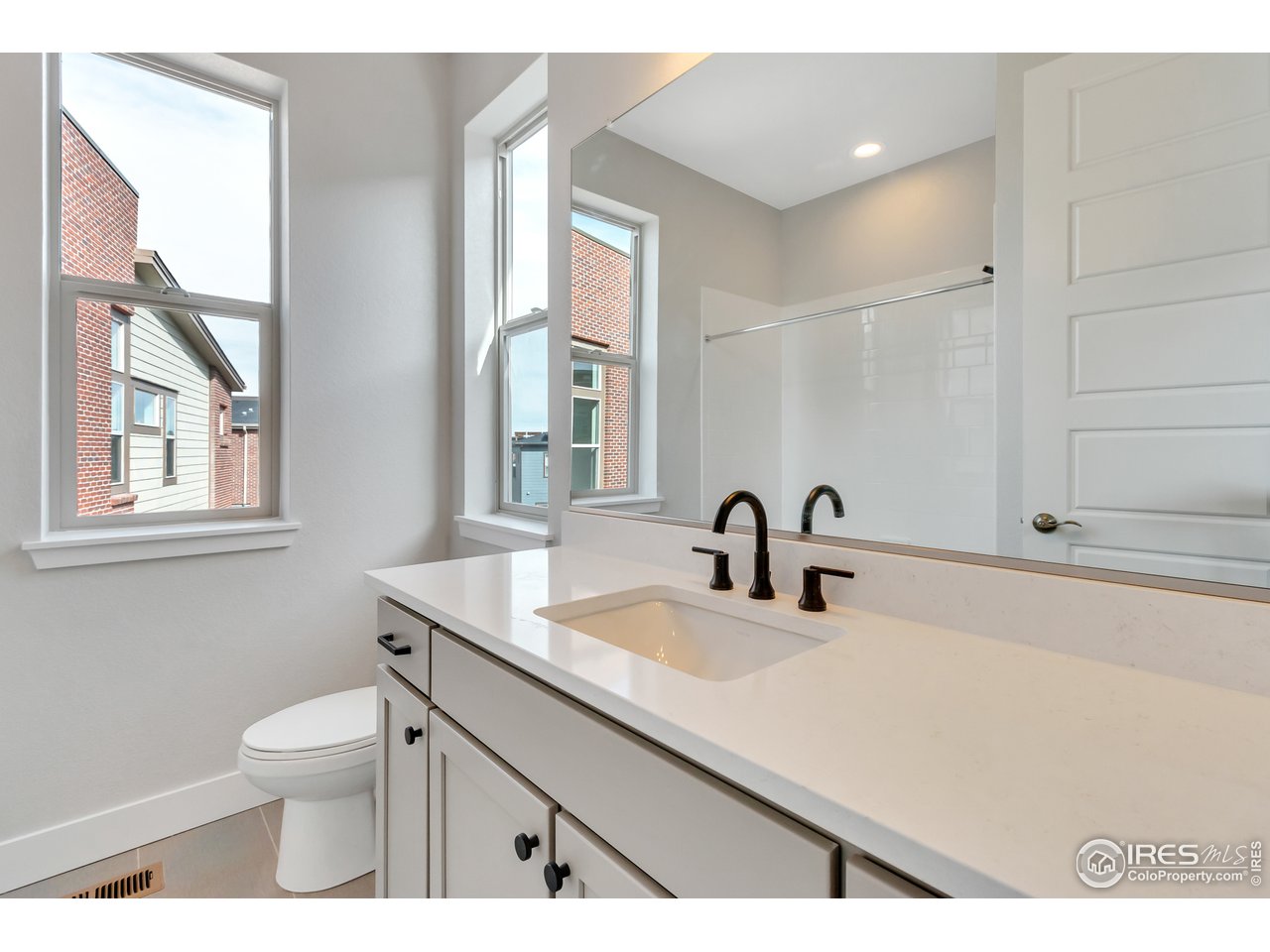 587 Canary Lane Superior, CO 80027 - Photo 22 of 22 a bathroom with a sink a toilet and a window