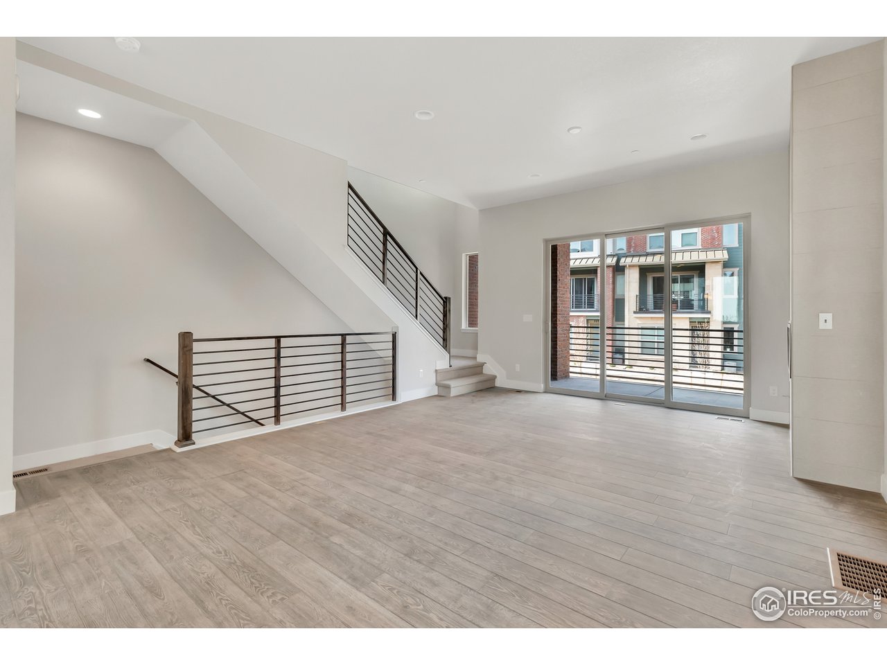 587 Canary Lane Superior, CO 80027 - Photo 3 of 22 a view of an empty room with wooden floor and stairs