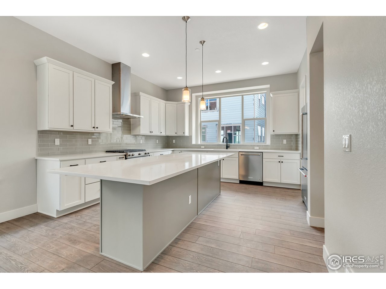 587 Canary Lane Superior, CO 80027 - Photo 5 of 22 a kitchen with a sink window and cabinets