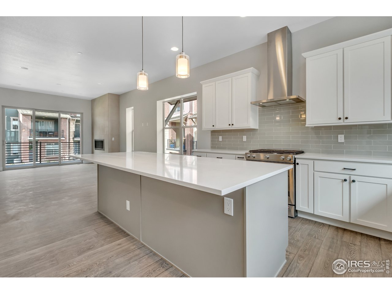 587 Canary Lane Superior, CO 80027 - Photo 7 of 22 a kitchen with kitchen island a sink stainless steel appliances and cabinets