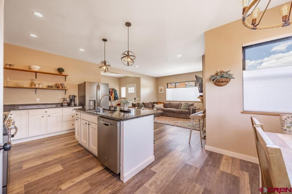 770 North Laura Street Ridgway, CO 81432 - Photo 12 of 45 a kitchen with stainless steel appliances granite countertop a sink a stove and refrigerator