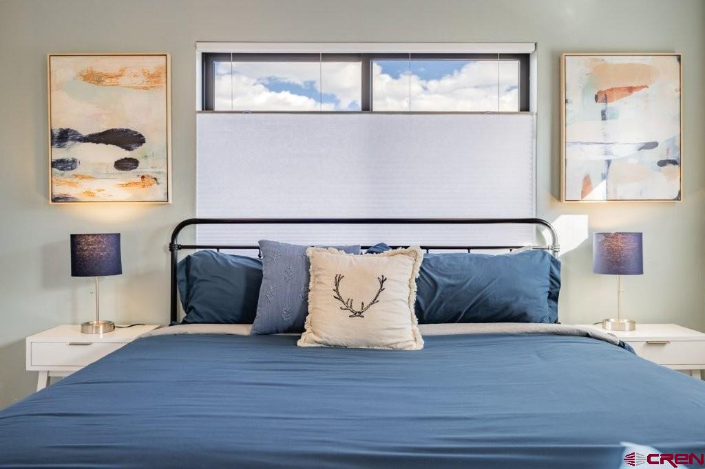 770 North Laura Street Ridgway, CO 81432 - Photo 13 of 45 a large bed sitting next to a lamp