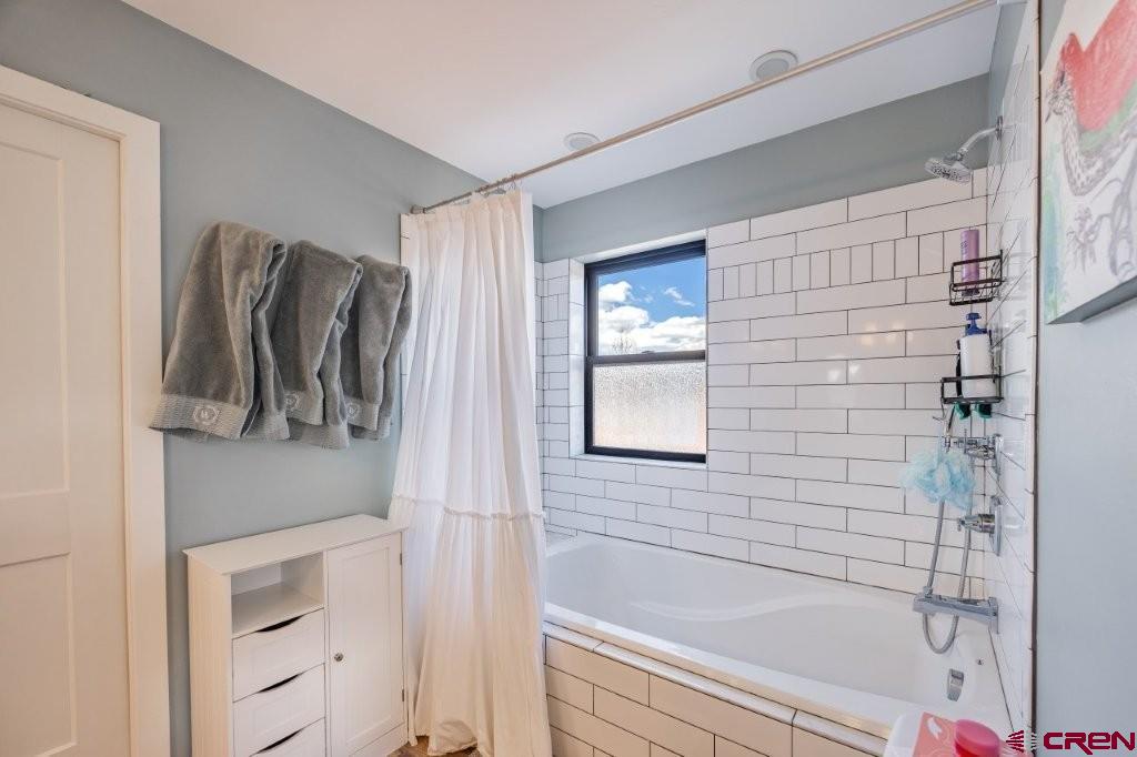 770 North Laura Street Ridgway, CO 81432 - Photo 16 of 45 a bathroom with a bathtub and a shower