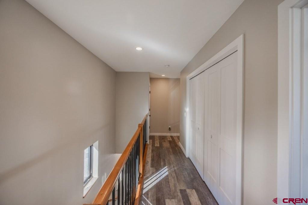 770 North Laura Street Ridgway, CO 81432 - Photo 18 of 45 a view of a hallway with wooden floor and stairs