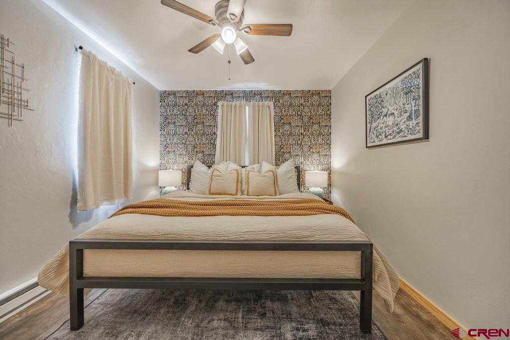 770 North Laura Street Ridgway, CO 81432 - Photo 38 of 45 a bedroom with a bed and a chandelier