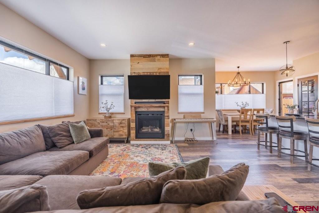 770 North Laura Street Ridgway, CO 81432 - Photo 6 of 45 a living room with furniture flat screen tv and a fireplace