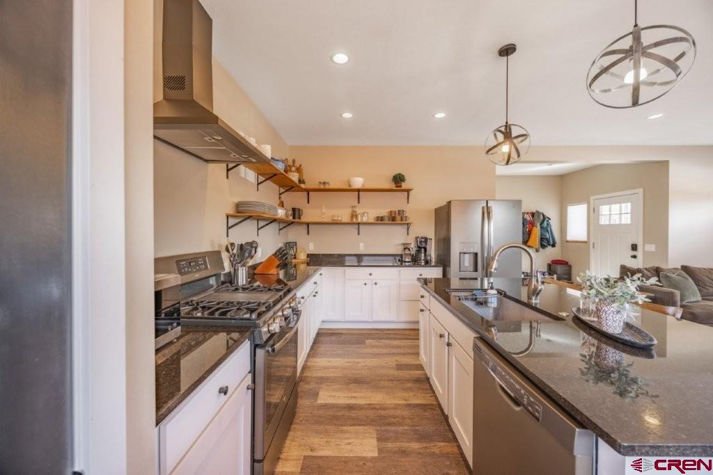 770 North Laura Street Ridgway, CO 81432 - Photo 10 of 45 a large kitchen with kitchen island a large counter top appliances and cabinets