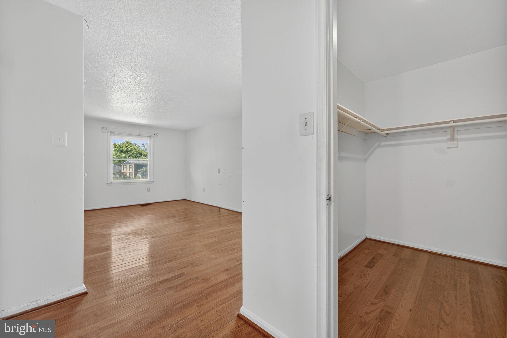 7124 Whetstone Road Alexandria, VA 22306 - Photo 16 of 39 Bedroom with hardwood floors and white walls