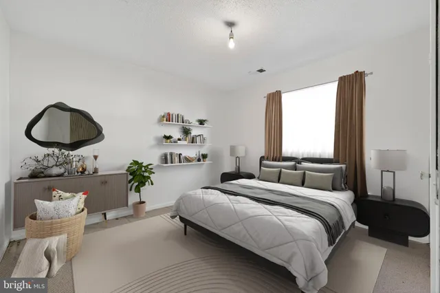 a bedroom with a bed and chandelier