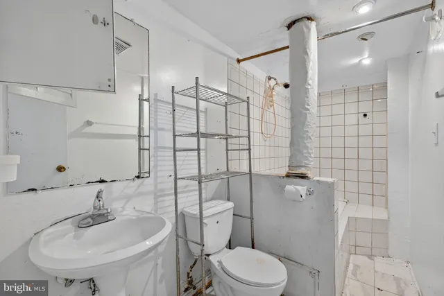 a bathroom with a sink toilet and shower
