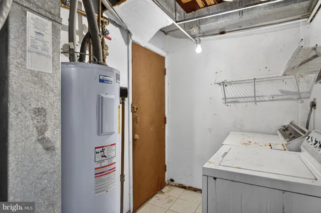 a view of a house with brick walls and a yard with plants