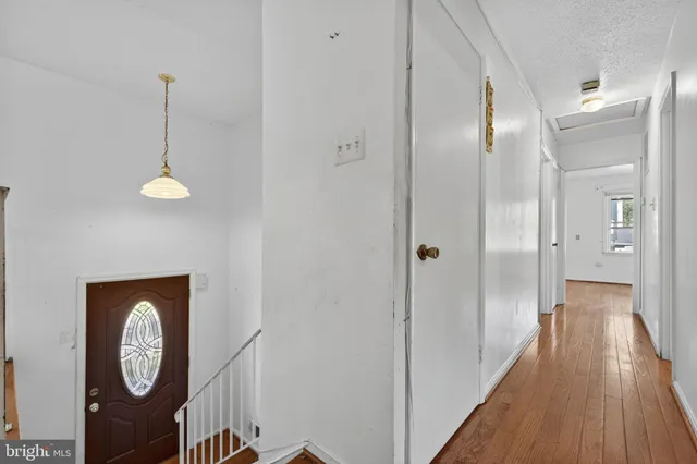a view of a hallway with wooden floor