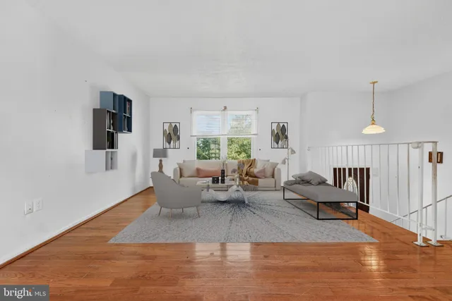 a living room with furniture window and wooden floor
