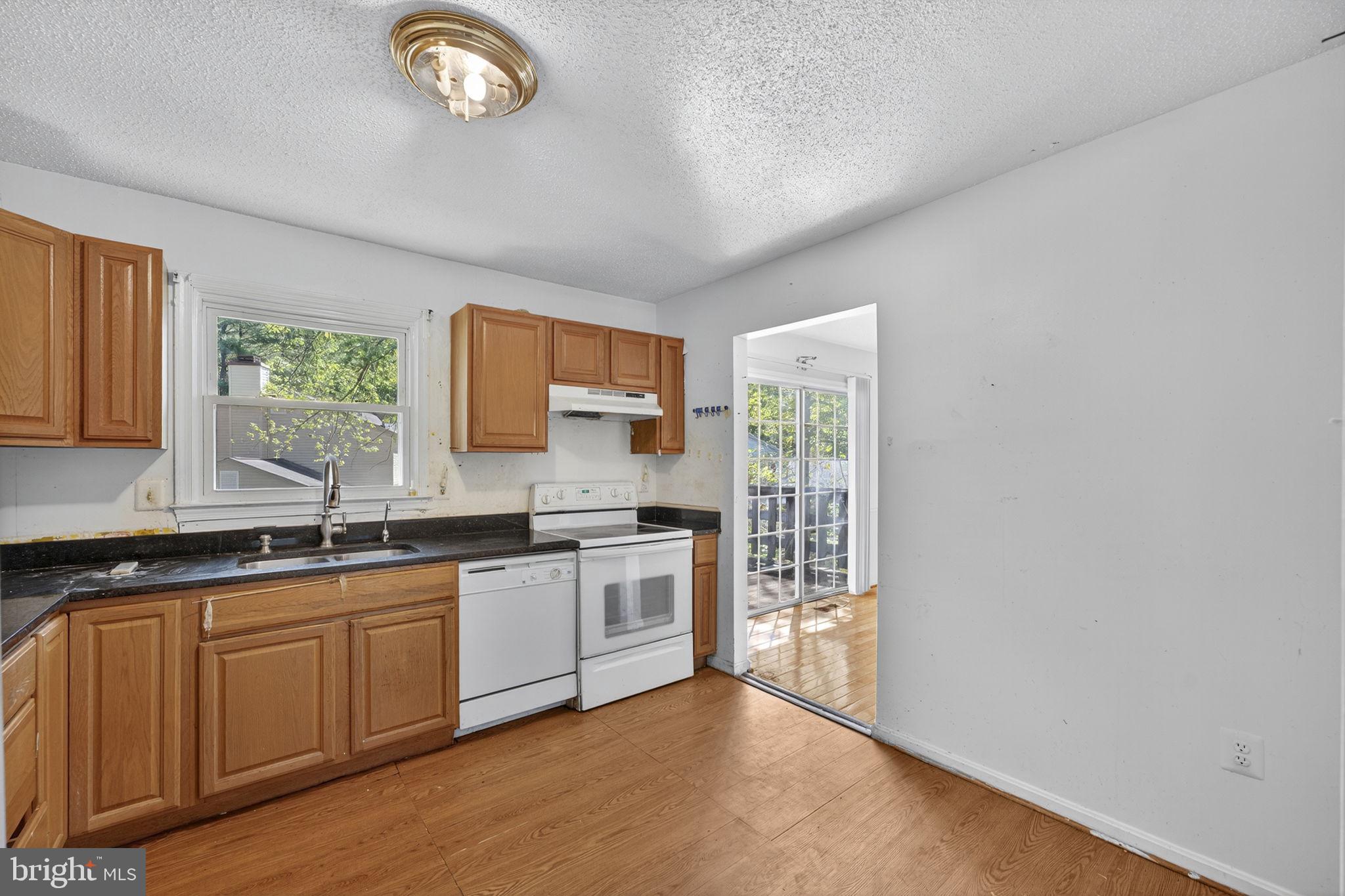 7124 Whetstone Road Alexandria, VA 22306 - Photo 10 of 39 Functional kitchen with warm wood cabinetry